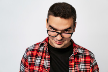 stylish glasses with black rim on a man in a plaid shirt in the studio on a white background. Close-up