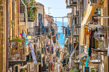 A cozy street in Cefalù on a sunny summer day. Sicily, southern Italy. - obrazy, fototapety, plakaty