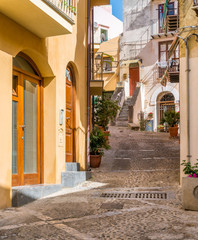 Obraz premium A cozy street in Cefalù on a sunny summer day. Sicily, southern Italy.