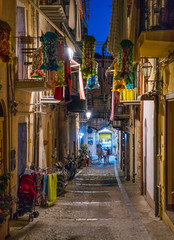 A cozy street in Cefalù in the evening. Sicily, southern Italy.