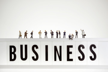 Business word with crowd of miniature business people