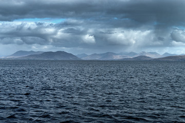 View from a boat, mainland Ireland. Stormy weather approaching, Grey skys.