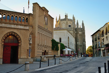 Toledo, Spain - September 24, 2018: Facade of the School of Art and the Monastery of San Juan de los Reyes in the background.