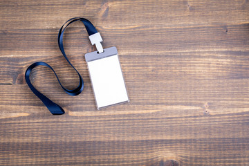 White empty staff identity mockup with blue lanyard. Name tag, ID card. Wood texture background
