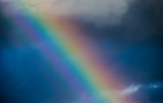 Rainbow In The Dark Blue Sky Close Up