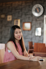 Young happy woman sitting modern office.