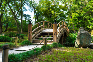 A quaint arched bridge spanning a brook in Richmond, Virginia. This bridge is located on the beautiful land inside of Maymont Park.