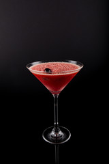 Drink in Martini Glass, Red Slush Ice summer drink with cherry on top, isolated on black background
