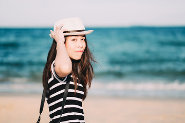 Young asian woman enjoy her tropical beach vacation.