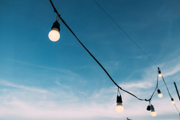 String wired bulb on blue sky.