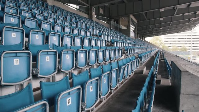 Numbered flip down seats at empty sport stadium
