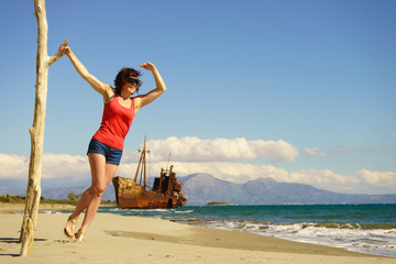 Fototapeta na wymiar Tourist woman on beach enjoying vacation