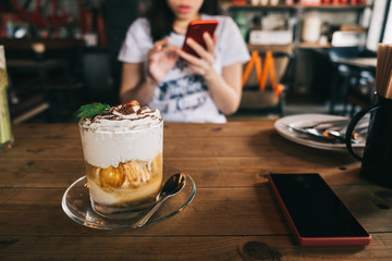 Young asian woman having breakfast in vintage cafe.