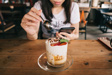 Young asian woman having breakfast in vintage cafe.