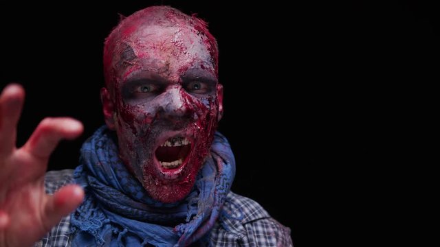 Zombie Maniac is scary of his teeth trying to bite the dark background of darkness