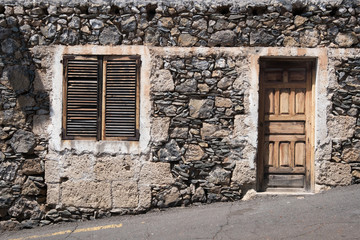 old  house  with wooden door and natural stone facade