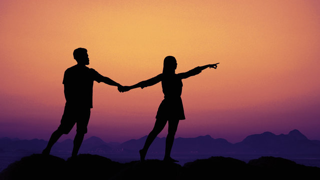 Silhouette of a couple in love at sunset as symbol for wedding