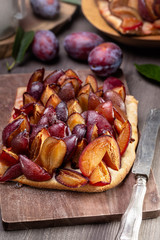 German plum cake on wooden table. Pflaumenkuchen