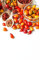 Medicinal plants and herbs composition: 
yellow and red wild dog rose, bunch branch  types Rosa canina hips, essential oil. hearbal tea  