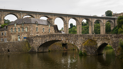 Fototapeta premium Old stone bridges in Dinan on a cloudy day in summer