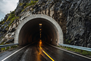 Asphalt road leading to tunnel