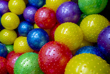 Fototapeta na wymiar colorful lots of big bumpy plastic air balls
