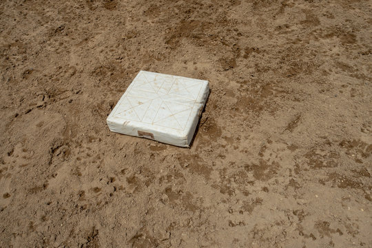 white home plate baseball sandy dirt field