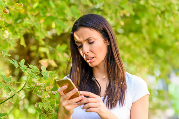 Fototapeta premium A woman receiving bad news on her Smartphone 
