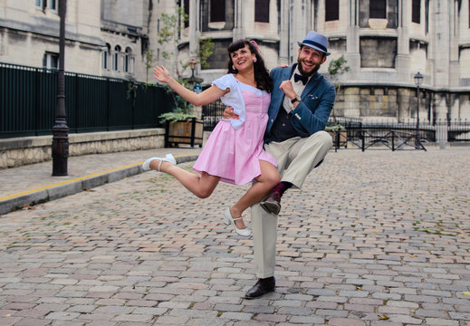 Couple dancing in Sacre Coeur of Montmartre Paris with fifties dress