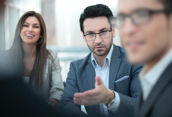 close up.the project Manager is talking to the employee at the meeting