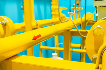 Yellow gas pipeline valve open ,two ways arrow, close signs closeup. Gas pipeline with a valve and a manometer. Transportation of natural gas