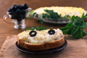 Toasted toast sandwich with egg salad, crab meat, cheese and mayonnaise.