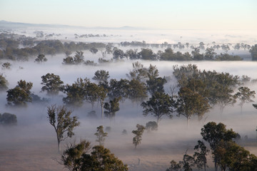 Hot Air Balloon flight over Gold Coast Hinterland, Queensland, Australia at sunrise in mid winter