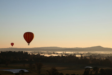 Hot Air Balloon flight over Gold Coast Hinterland, Queensland, Australia at sunrise in mid winter