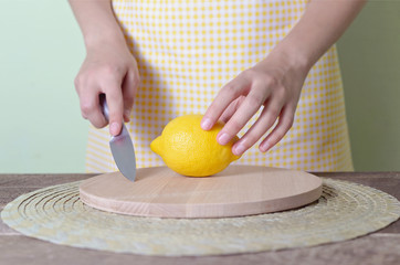 woman cuts lemon