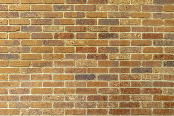 yellow orange solid brick wall with cement grouting
