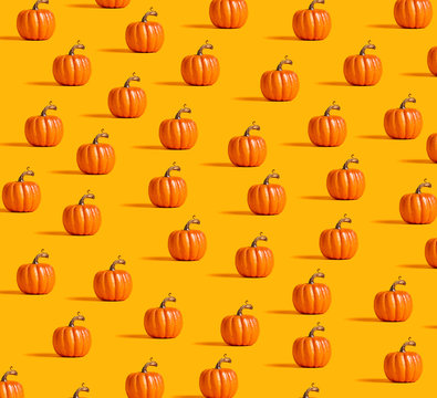 Autumn orange pumpkins on an orange background