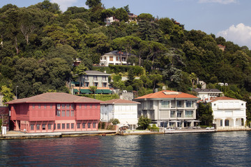 Fototapeta na wymiar View of historical, old Turkish / Ottoman houses by Bosphorus on Asian side of Istanbul. It is a sunny summer day.