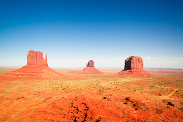 sunset in the desert with scenic rocks and monument