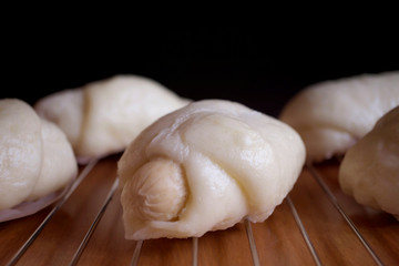 Fototapeta na wymiar blur homemade Chinese sausage steamed buns on brown table
