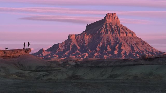 Hikers Looking At Desert Mountain At Sunset