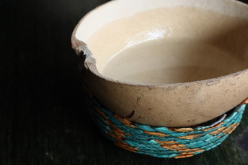 Mezcal served traditionally in a jicara in Mexico City