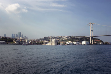Naklejka premium View of old, historical Ortakoy Mosque by Bosphorus, the bridge and European side of Istanbul.