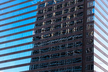 Fototapeta na wymiar Modern glass building and reflection in its glass from a nearby byilding
