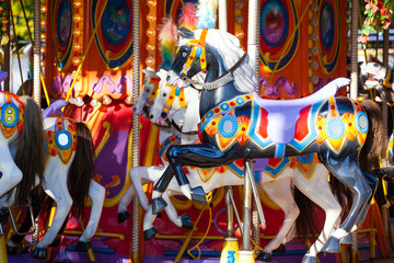 horses on a carousel in an amusement park