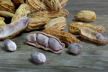 Peanut boiled seed falling from bamboo basket on wooden ground dim light