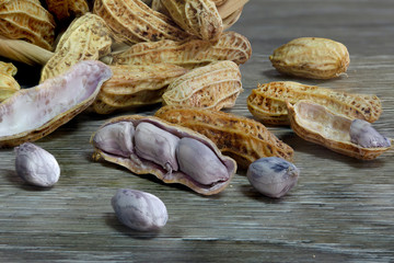 Peanut boiled seed falling from bamboo basket on wooden ground dim light
