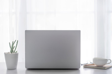 Office desk table with laptop computer, supplies with copy space in the office.