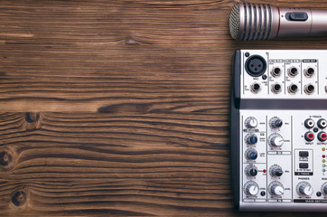 Audio recording studio concept. Microphone and audio sound mixer on the table.