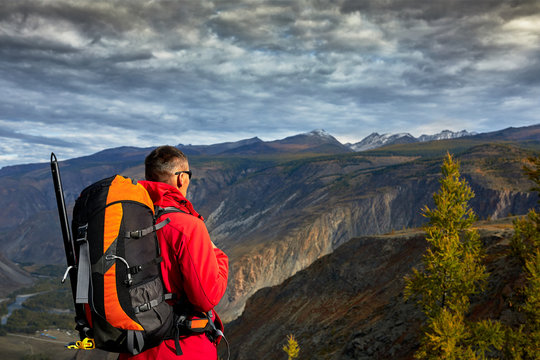 Young Man Traveler relaxing outdoor with rocky mountains on background Autumn vacations and Lifestyle